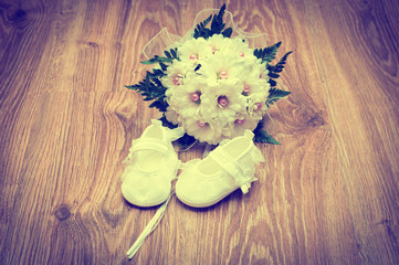 shoes and bouquet on a wooden floor