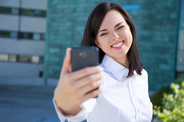 funny business woman making selfie photo on smartphone
