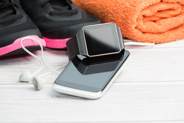 Fitness equipment, smart watch and phone.