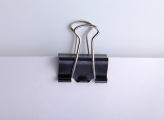 Black paper clip on paper
