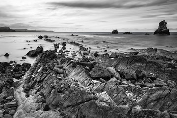 Stunning tonal black and white landscape of Mupe Bay with rocks