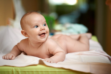 cheerful child lying on changing table