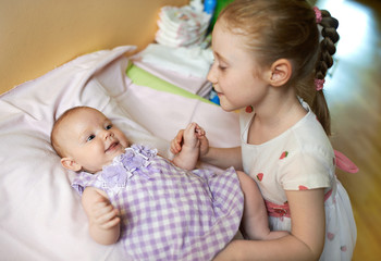  older sister takes care of the little girl