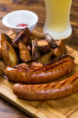 Grilled sausages with roast potato with spices