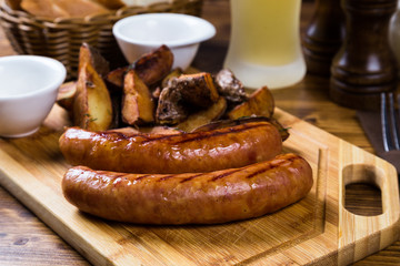 Grilled sausages with roast potato with spices