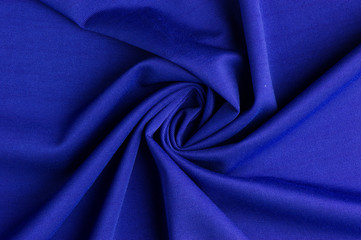 Spiral folds on blue cloth