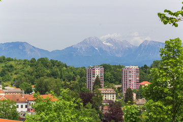 Two high-rise buildings on the background of the Alps.