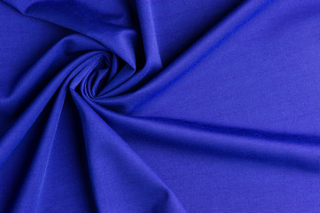 Spiral folds on blue cloth