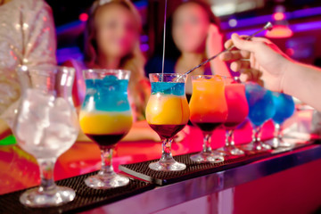 Barman  prepares exotic cocktails