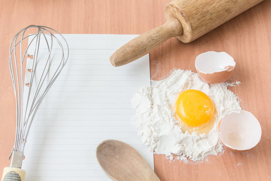 Ingredients for baking cake with egg on a wooden worktop - Rusti