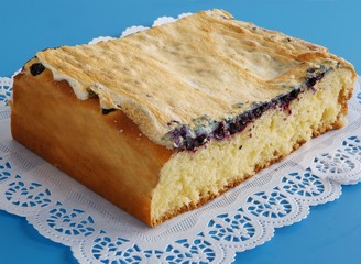 sweet bun with icing and black berries