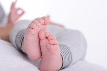 closeup shot of baby foot laying down on a white blanket