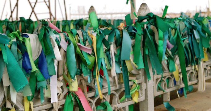 Traditional green ribbons on the fence of muslim tomb