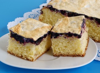 sweet bun with blackberries and icing as dessert