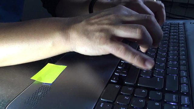 Hands typing fast on a computer keyboard - time lapse movie - loop
