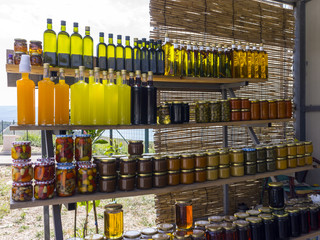 home made colorful liqueur and vinegar bottles on a market in croatia