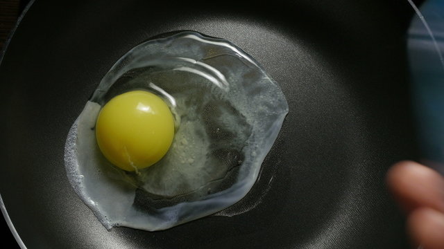 Egg in frying pan. 4K UHD 2160p footage.
