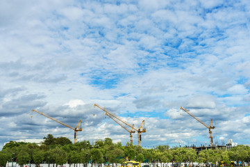 Crane construction in the city under the blue sky