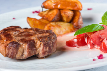 Grilled meat with tomato salad