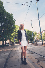 Naklejka premium Beautiful girl posing in the city streets