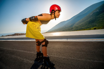 Sport woman with rollers on the highway © rh2010