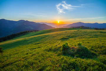 Beautiful summer sunrise in mountains.