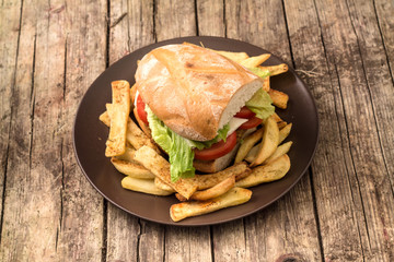 Vegetarian lentil burger in wholewheat bun with lettuce and tomato accompanied by French fries