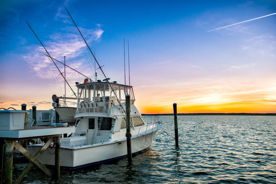 Fishing Boat On The Pier At Sunset On The Lake