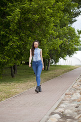 Fototapeta premium Young beautiful girl in blue jeans and a blue shirt on the backg