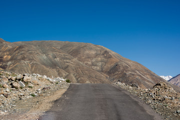 Road to Pangong Lake with light and shade on mountain.Blur on fo