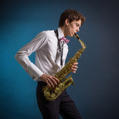 Fototapeta na wymiar A man plays the saxophone
