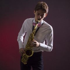 A man plays the saxophone