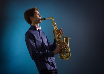 A man plays the saxophone