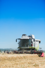 Plakat combine harvester agriculture machine harvesting golden ripe wheat field