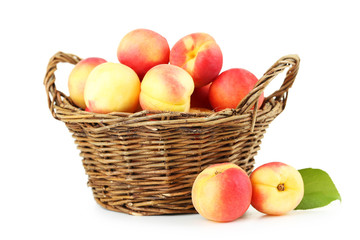 Naklejka na ściany i meble Fresh apricots in basket on a white background