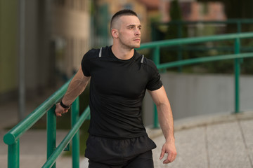 Young Sportive Man Doing Gymnastics Outdoors