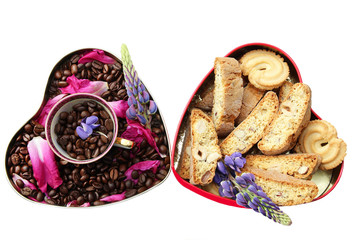 Coffee beans in the heart and tasty cookies also in the heart on isolated background