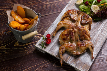 Roasted quails on a wooden board. - 86002755