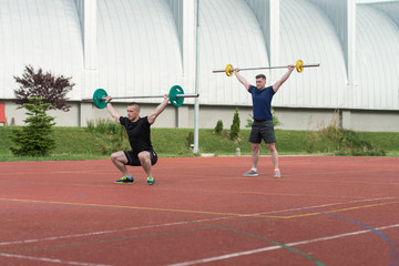 Young People Doing A Overhead Squat Exercise Outdoor