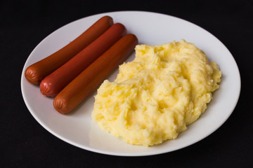 mashed potatoes sausages dark background