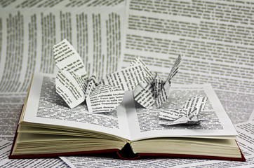 Origami butterflies coming out of a book