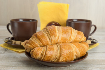 croissants and coffee in cups