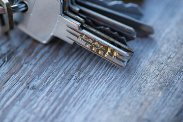 A bunch of old worn keys on the wooden surface