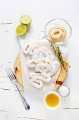 Fototapeta na wymiar sliced raw squid rings with lime, olive oil, breadcrumbs. Prepar