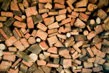 Background of dry chopped firewood logs in a pile