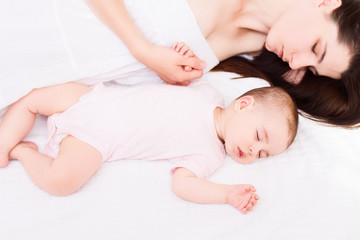Obraz na płótnie Canvas Beautiful sleeping baby with mom on white background