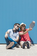 Fototapeta premium summer holidays, teenage and technology concept - couple of smil
