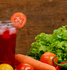 Fresh vegetable juices on wooden table