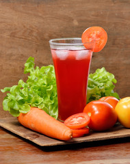Fresh vegetable juices on wooden table