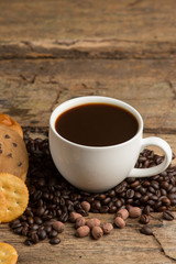 Cup of coffee on a wooden board and biscuits